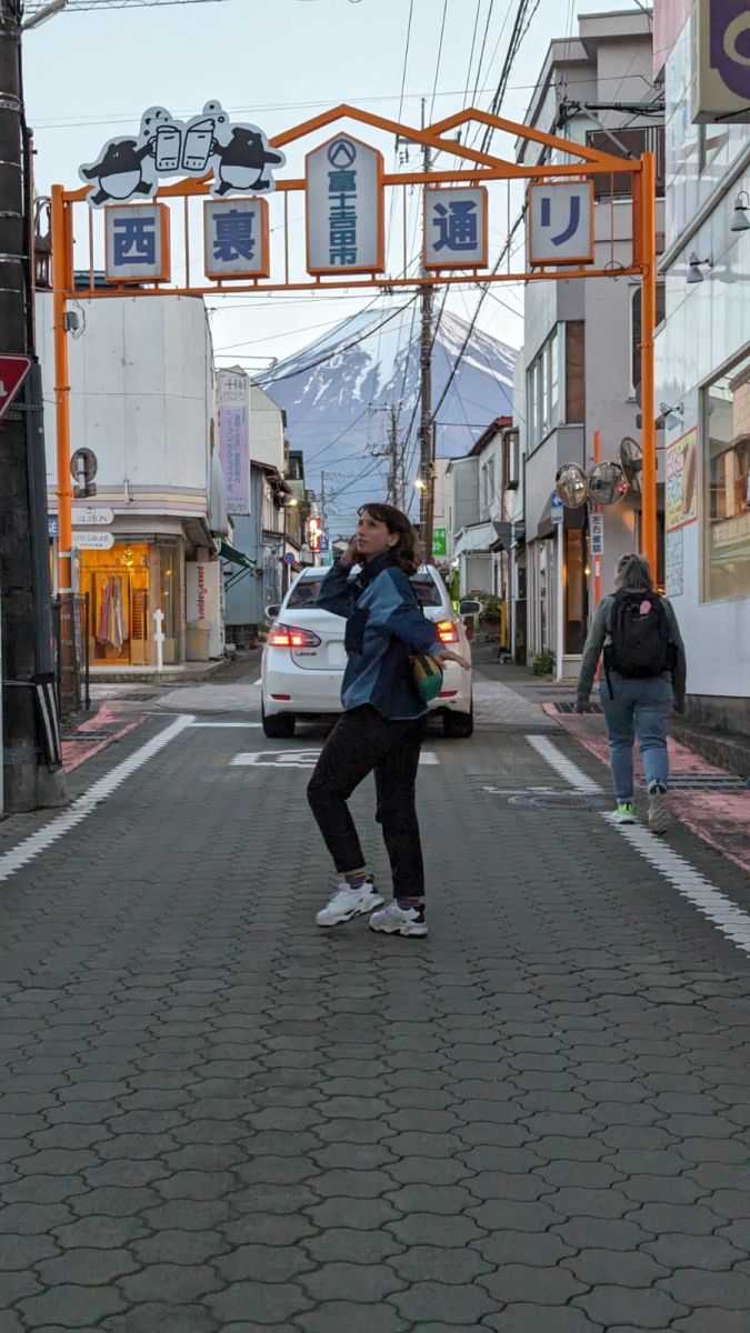 Jess in a Japan town with Mt Fuji in the background