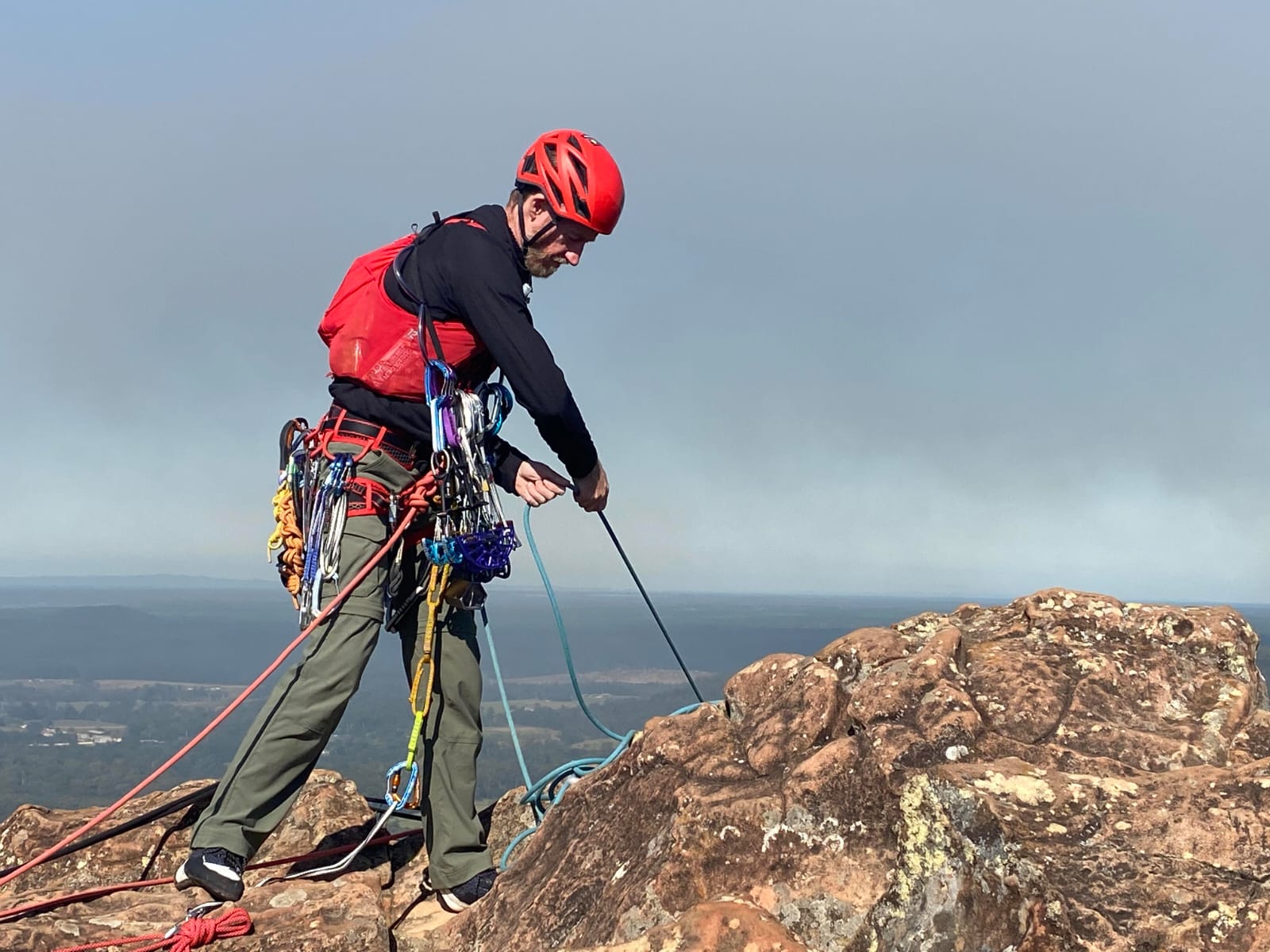 Christian using climbing gear while wearing Salomon Adv Skin 12 vest