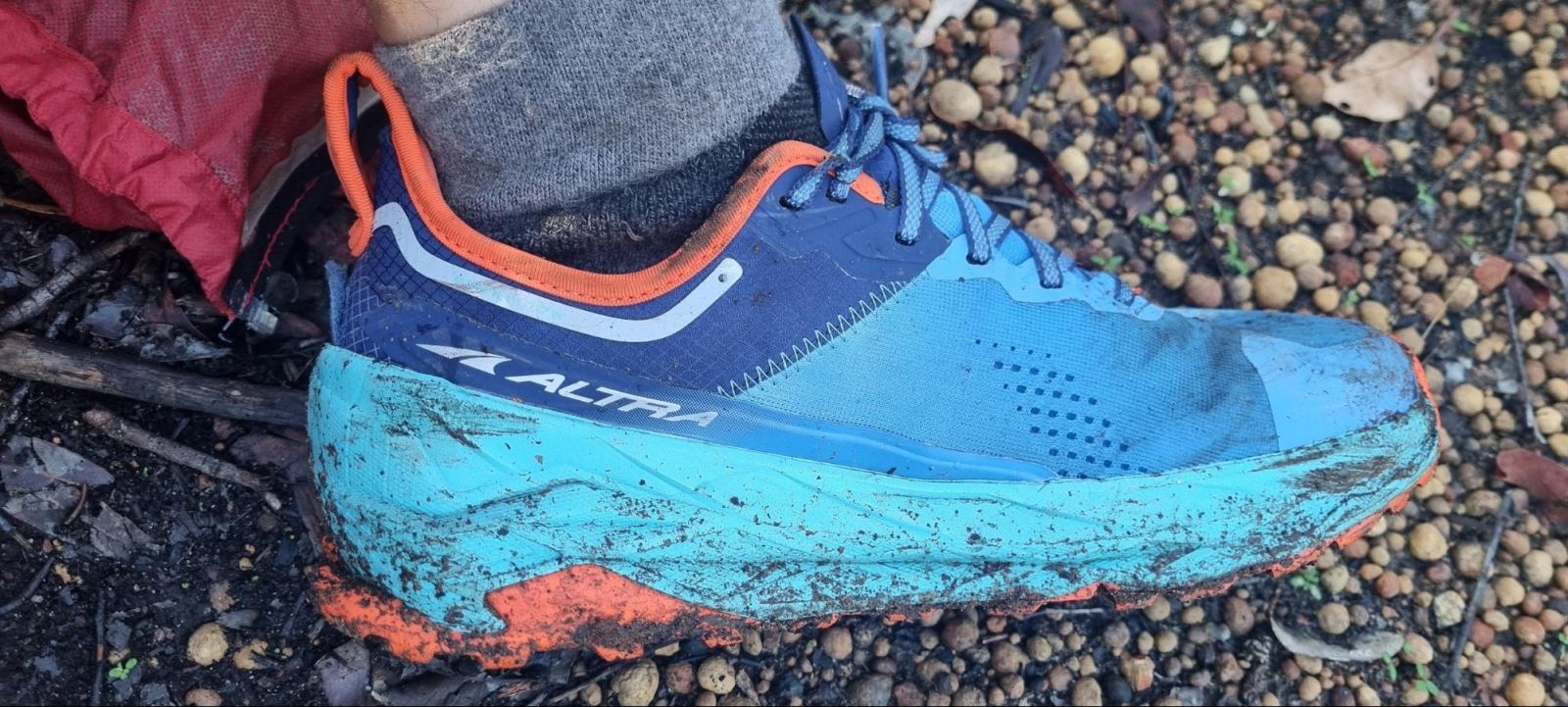 Close up of Reid wearing the Altra Olympus 5 Running Shoes in Blue and Orange