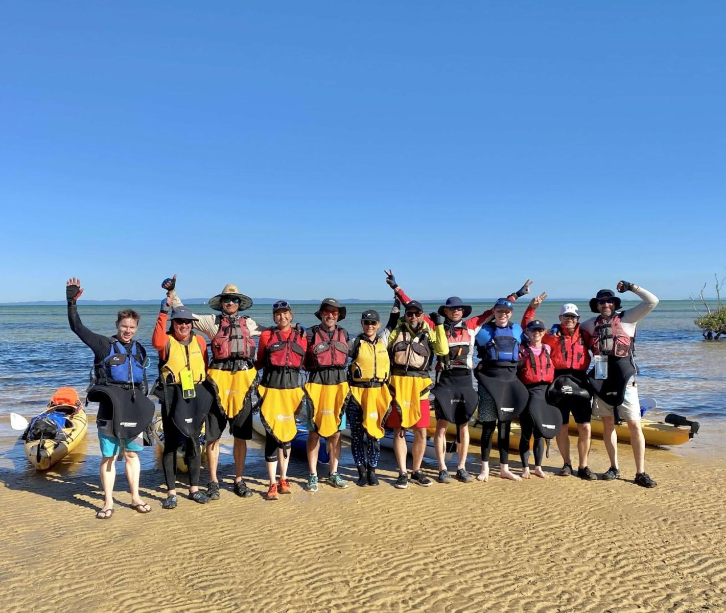 Group photo of all the kayakers together on the beach