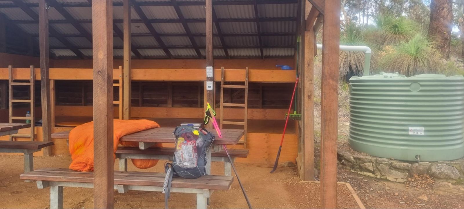 Reid's sleeping gear, pack and poles at a sheltered site