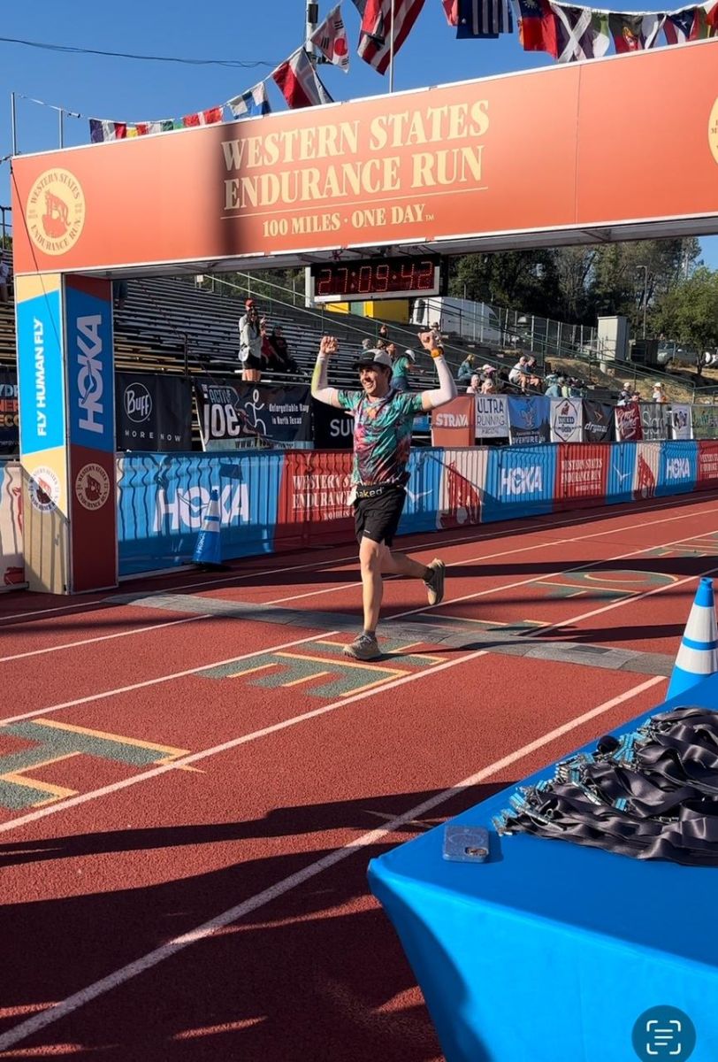 Ryan crossing the finish line at Western States with his arms in the air