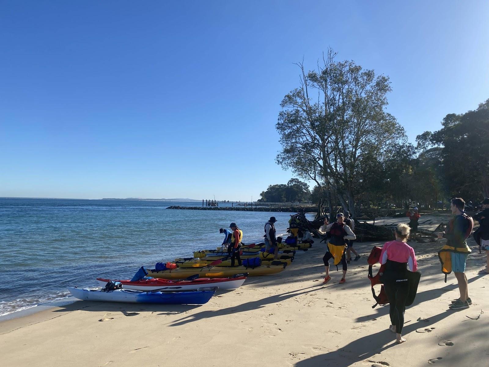 Kayakers prepping their gear on the beach